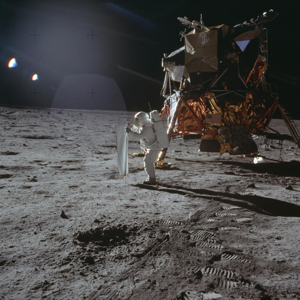 In this July 20, 1969 photo made available by NASA, Apollo 11 astronaut Buzz Aldrin works on a solar wind experiment device on the surface of the moon. (Neil Armstrong/NASA via AP)