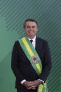 Brazil's President Jair Bolsonaro smiles during a meeting with his new cabinet at the Planalto Presidential palace, in Brasilia, Brazil, Tuesday, January 1, 2019. (AP Photo/Eraldo Peres)