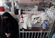 Newborn children who lost their mothers during the yesterday's attack lie on a bed at a hospital, in Kabul