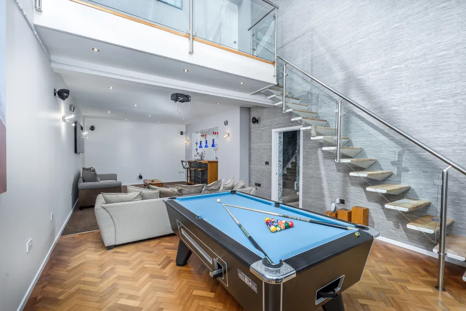The house features a games room with a bar, parquet flooring and a generous skylight. (SWNS)