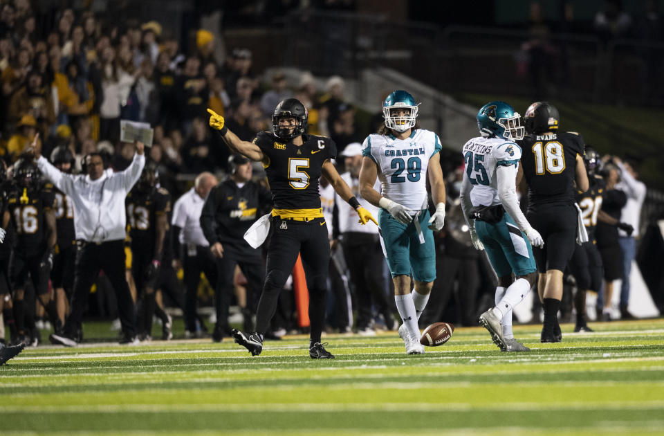 Appalachian State wide receiver Thomas Hennigan (5) signals a first down after a catch during the first half of the team's NCAA college football game against Coastal Carolina on Wednesday, Oct. 20, 2021, in Boone, N.C. (AP Photo/Matt Kelley).