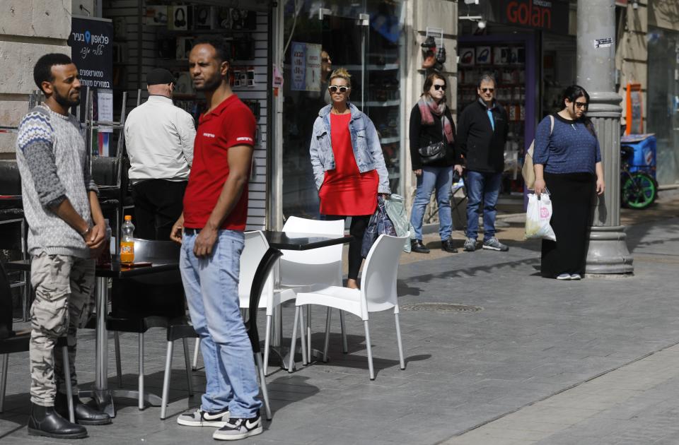 People stop and stand in silence on a Jerusalem's downtown street.&nbsp;