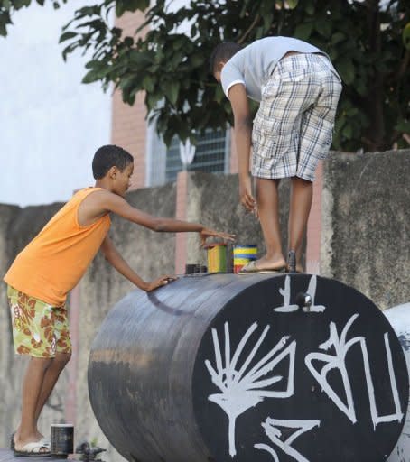 Two young photography students use their pin hole cameras at the favela da Mare shantytown in Rio de Janeiro, Brazil. Created by the NGO in 2005 and sponsored by TV Globo television network and the city government, the 'Pinhole Project' aims to teach photography to local residents aged 9 to 16, so they can show they own point of view about the problems of the society they live in