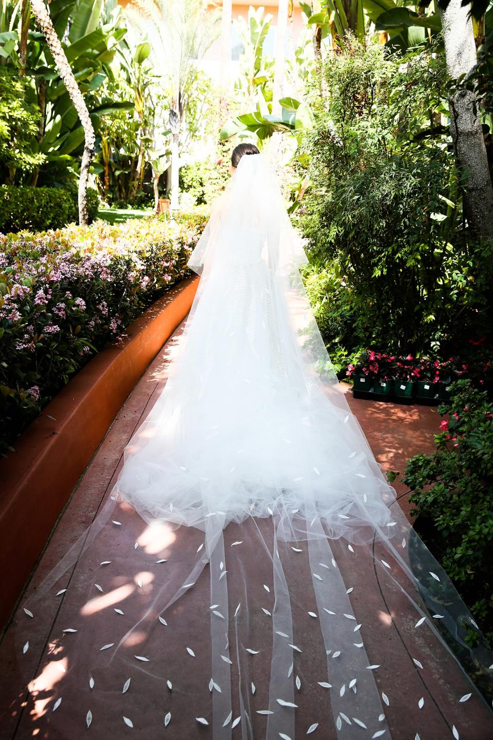 The bride wore Oscar de la Renta, inspired by her grandmother, for her greenery-filled ceremony at the Beverly Hills Hotel.
