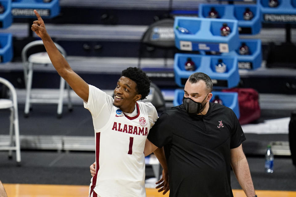 Alabama forward Herbert Jones (1) waves to fans as he leaves the court following a first-round win. (AP Photo/Michael Conroy)