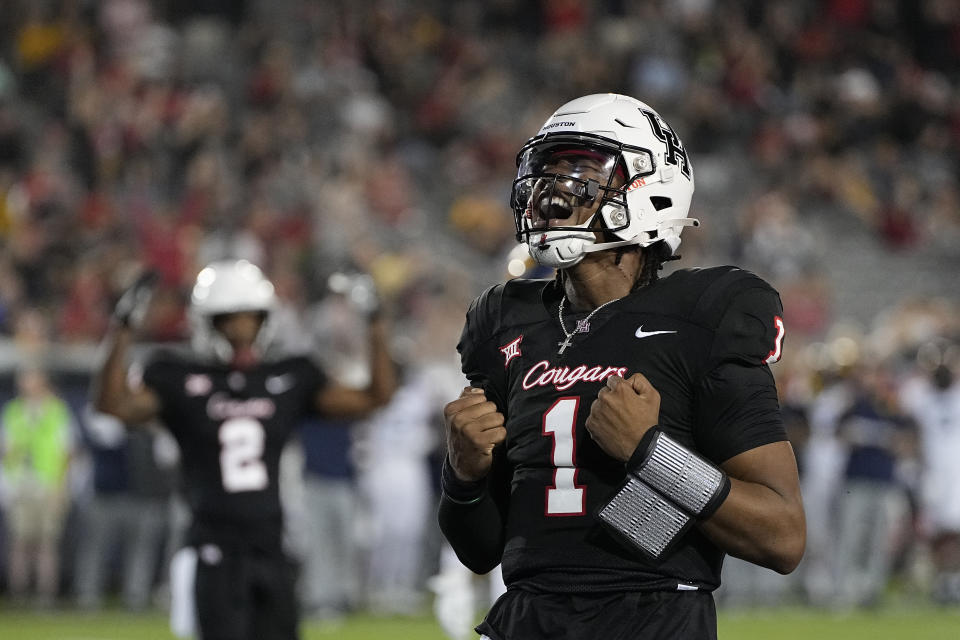 Houston quarterback Donovan Smith (1) celebrates after rushing for a touchdown against West Virginia during the second quarter of an NCAA college football game Thursday, Oct. 12, 2023, in Houston. (AP Photo/Kevin M. Cox)