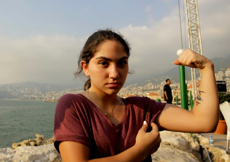 A Lebanese girl shows her muscles during an arm wrestling championship in the coastal city of Jounieh on July 13, 2018