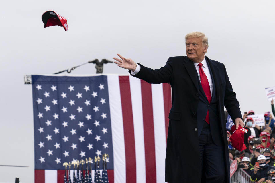 President Donald Trump throws a hat to supporters as he arrives to speak at a campaign rally at Altoona-Blair County Airport, Monday, Oct. 26, 2020, in Martinsburg, Pa. (AP Photo/Alex Brandon)