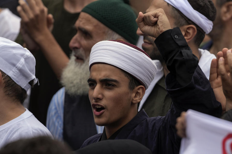 Turkish demonstrators chant slogans while holding Turkish flags during a anti LGBTI+ protest, in Fatih district of Istanbul, Sunday, Sept. 18, 2022. (AP Photo/Khalil Hamra)