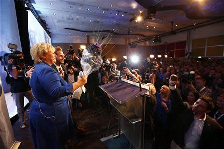 Norway's main opposition leader Erna Solberg of Hoyre (L) speaks to party members while waiting for the results of the general elections in Oslo September 9, 2013. REUTERS/Heiko Junge/NTB Scanpix