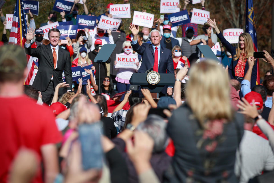 Vice President Mike Pence waves to supporters at a Defend the Majority Rally in Canton Georgia along with Sen. David Perdue (R-GA) and Sen. Kelly Loeffler (R-GA) on Friday, Nov. 20, 2020 in Canton, GA. (Jason Armond / Los Angeles Times via Getty Images)