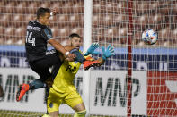 Vancouver Whitecaps goalkeeper Maxime Crepeau, rear, defends against Los Angeles Galaxy Chichartio (14) in the second half during an MLS soccer match Wednesday, June 23, 2021, in Sandy, Utah. (AP Photo/Rick Bowmer)