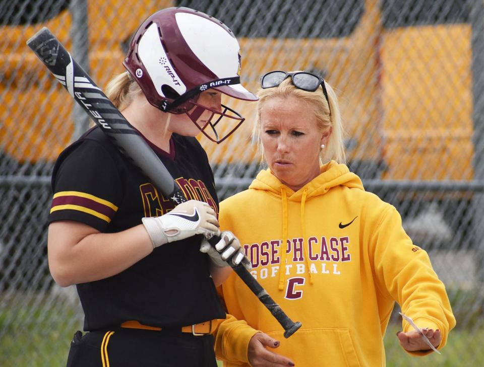 Case head coach Shannon Silva talks with Brooke Orton prior to her at bat in Wednesday's Division IV Round of 32 game against Advanced Math & Science.
