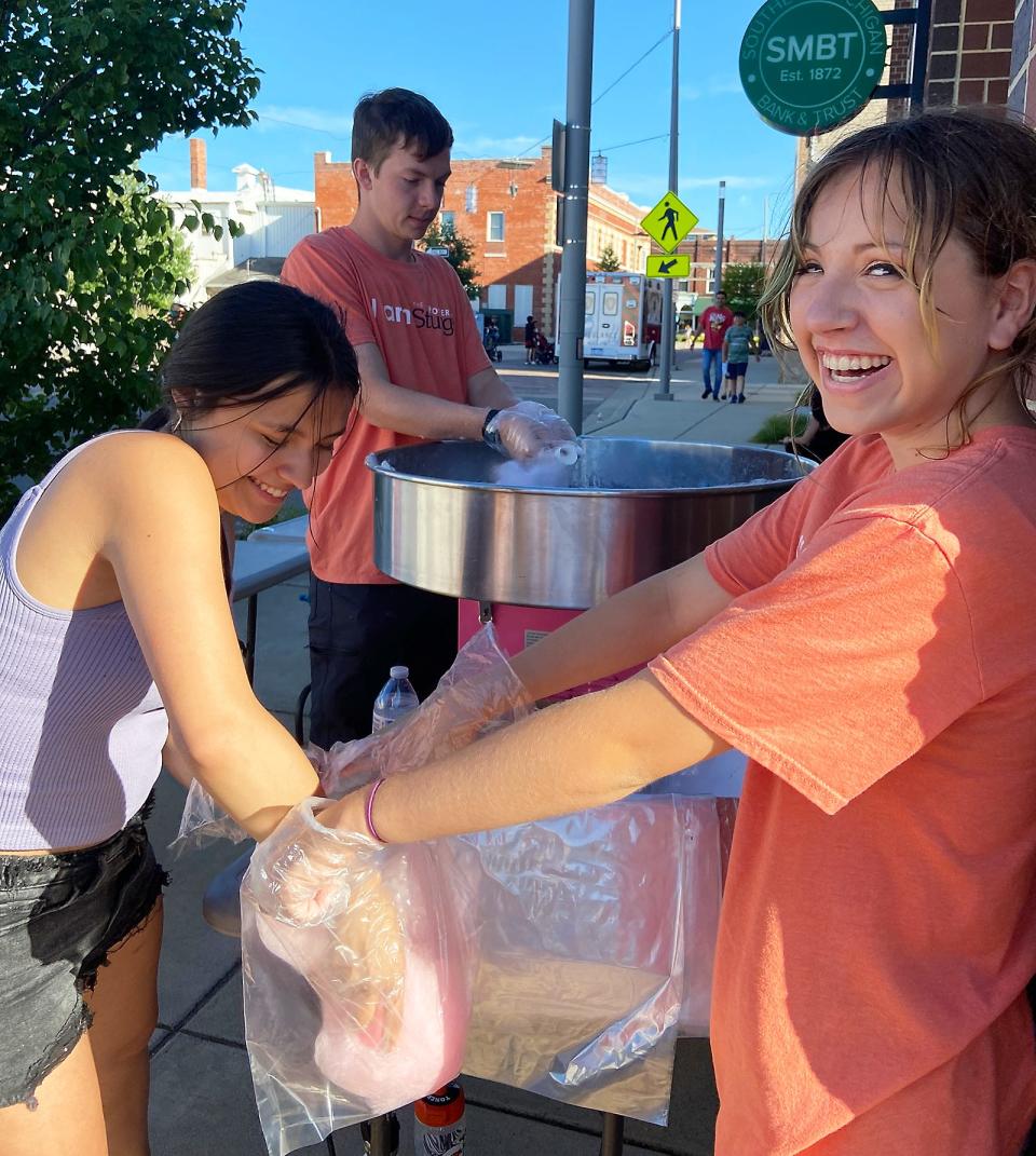 YAC members, including Liliana Luna, Matthew Toner and Caroline Hughes, were busy Wednesday preparing cotton candy at "Family Night,"