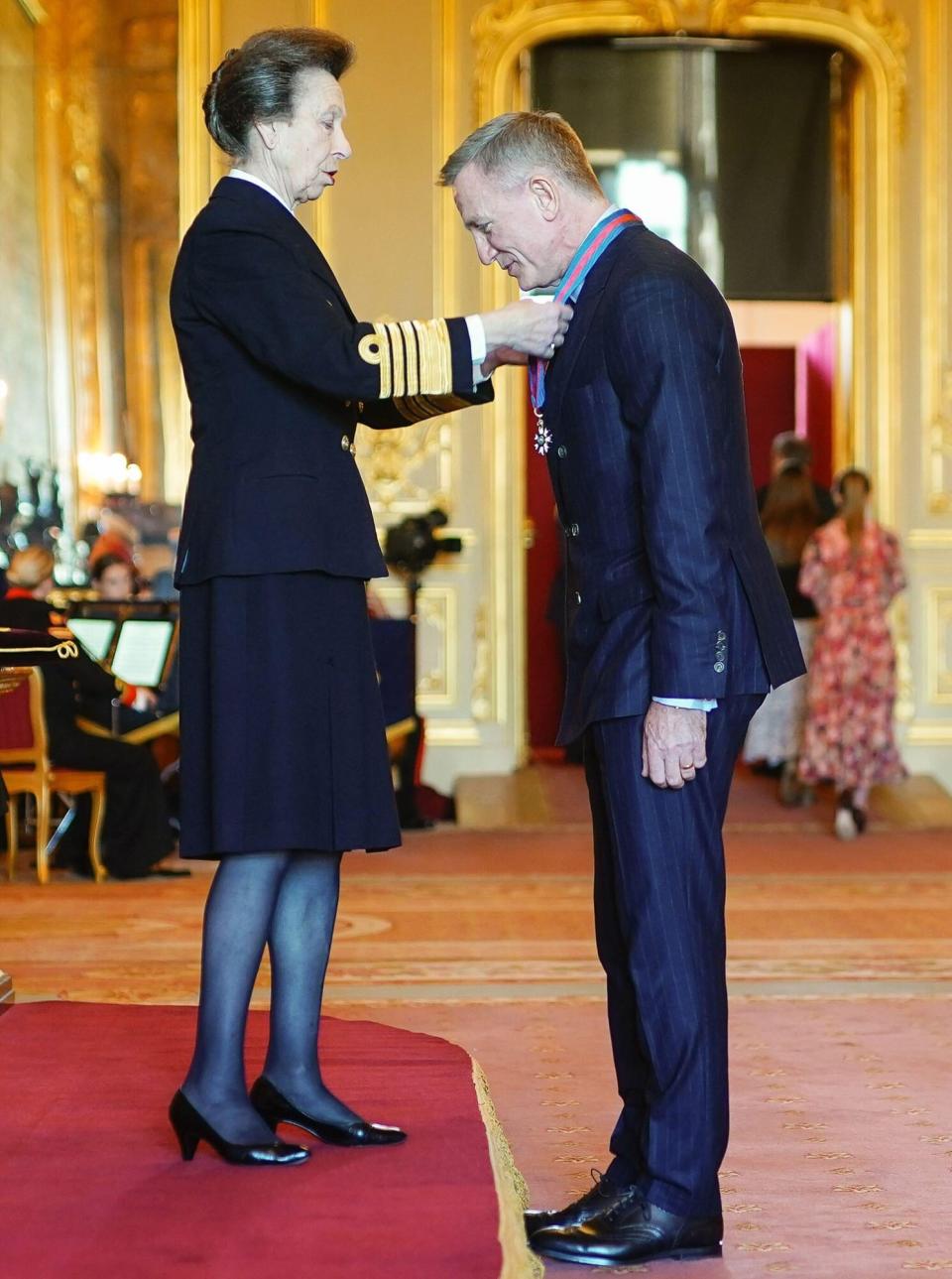 Daniel Craig is made a Companion of the Order of St Michael and St George by the Princess Royal during an investiture ceremony at Windsor Castle