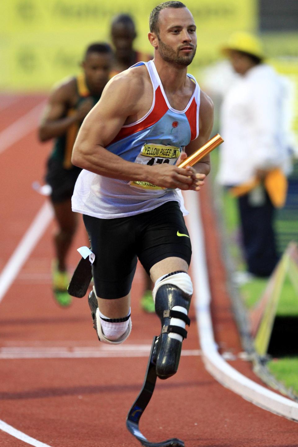 PORT ELIZABETH, SOUTH AFRICA - APRIL 14: Oscar Pistorius runs with the relay baton during day 2 of the Yellow Pages South African Senior Championship at Nelson Mandela Metropolitan University on April 14, 2012 in Port Elizabeth, South Africa. (Photo by Richard Huggard/Gallo Images/Getty Images)