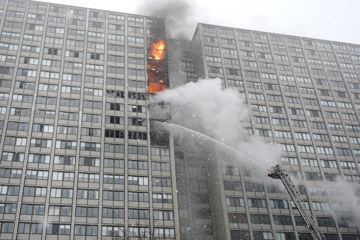 Flames leap skyward out of the Harper Square cooperative residential building in the Kenwood neighborhood of Chicago, Wednesday, Jan. 25, 2023. (AP Photo/Charles Rex Arbogast)