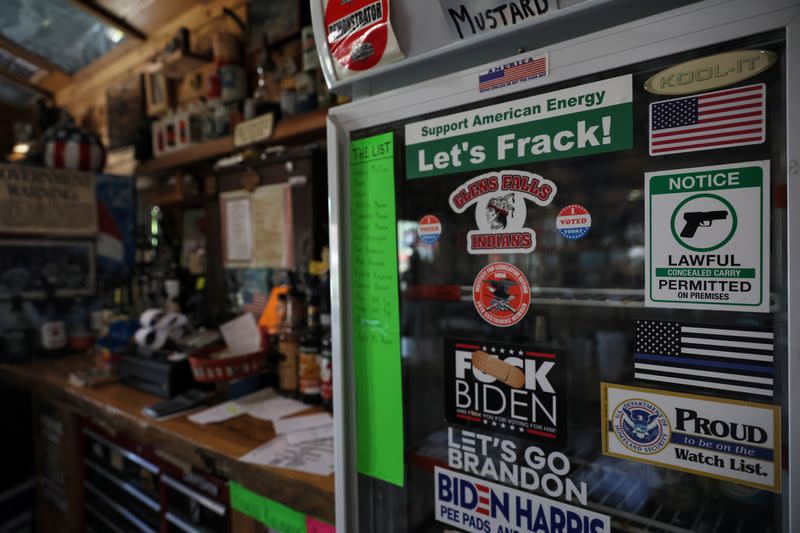 Stickers are posted on a refrigerator door with other memorabilia at Sporty's Iron Duke Saloon in Minerva