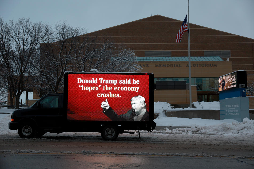 A truck bears a sign criticizing Trump 