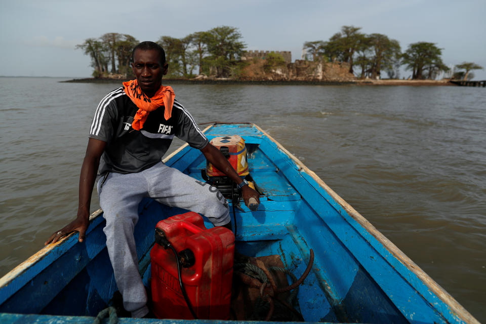 Abdoulie Jabang,30, a boat captain who transport tourists to Kunta Kinte Island, leads his boat off  as he leaves the island on the Gambia River, near Jufureh, Albreda, Gambia. (Photo: Zohra Bensemra/Reuters)