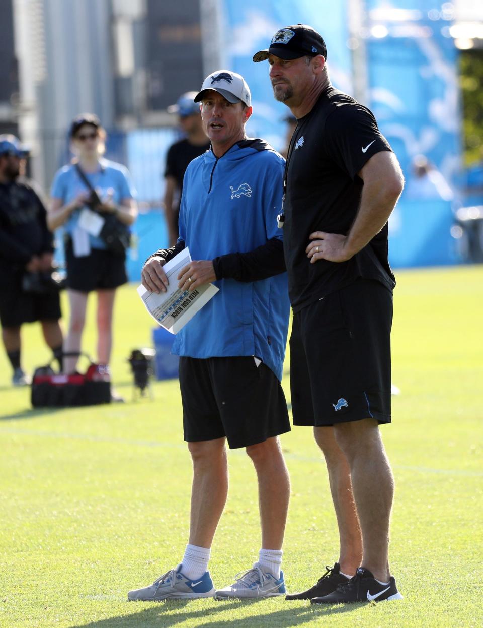 Lions special teams coordinator Dave Fipp and head coach Dan Campbell watch drills during practice Saturday, July 30, 2022 at the Allen Park practice facility.