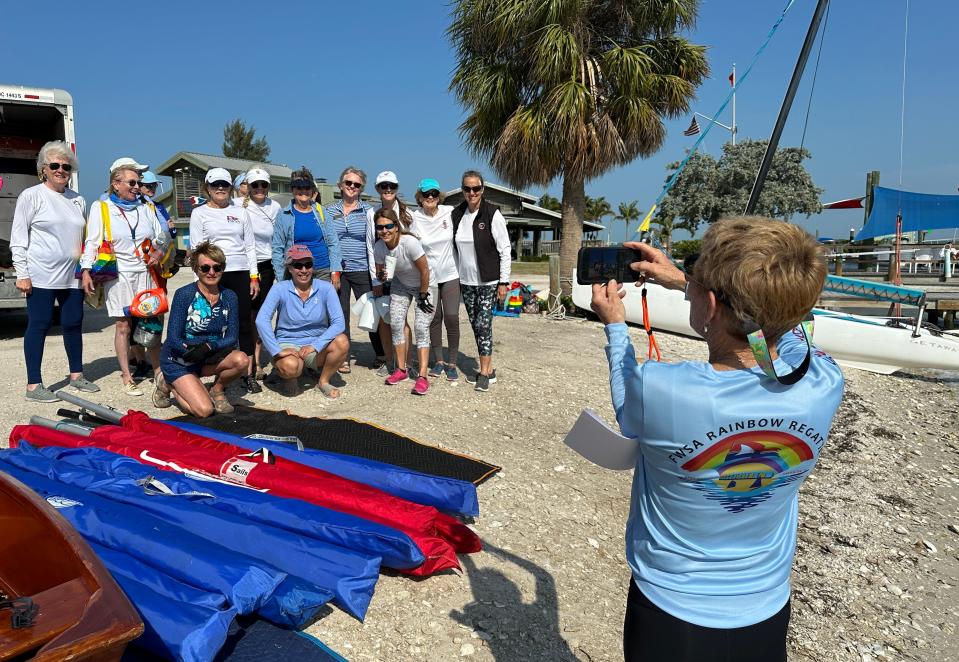 Members of Broad Reachers and Salty Sisters sailing clubs, both from St. Petersburg, pose for a photo together Wednesday as they prepare their prams for sailing in the Rainbow Regatta on Wednesday afternoon. High winds caused dangerous conditions in Sarasota Bay on Wednesday and Thursday leading to 75 disappointed solo sailors as this year's event was canceled.