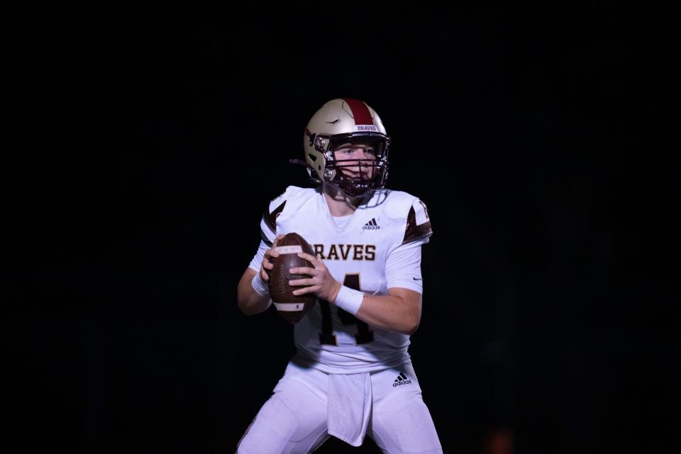 Brebeuf Jesuit Braves quarterback Maverick Geske looks for an opening during the game with Bishop Chatard Trojans on Friday, Aug. 18, 2023, at Bishop Chatard High School in Indianapolis. Trojans beat rivals Braves 49-23 in their first game of the 2023 season.