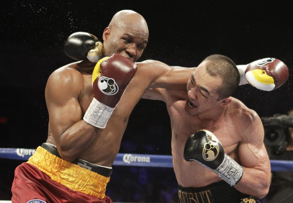 Bernard Hopkins, of the United States, and Beibut Shumenov, of Kazakhstan, fight during their IBF, WBA and IBA Light Heavyweight World Championship unification boxing match, Saturday, April 19, 2014, in Washington. Hopkins won by a split decision. (AP Photo/Luis M. Alvarez)