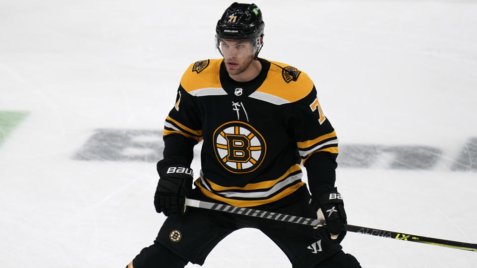 Boston Bruins left wing Taylor Hall, who was acquired in a trade with the Buffalo Sabres, stretches during warmups for the team's NHL hockey game against his former team, Tuesday, April 13, 2021, in Boston. (AP Photo/Charles Krupa)