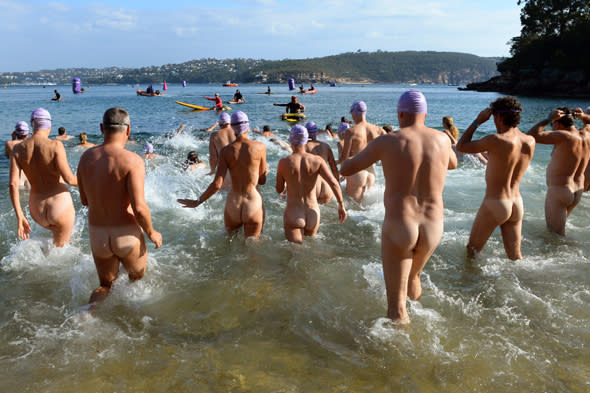 Competitors enter the water at the start the second annual Sydney Skinny where they take part in an attempt to break the world record for the largest nude ocean swim  a record set at last years inaugural event, in Sydney on February 23, 2014.  Over 700 people competed last year and the event is used to strike a blow against negative body image pressure and simply to enjoy a brilliant swim.     AFP PHOTO/William WEST        (Photo credit should read WILLIAM WEST/AFP/Getty Images)