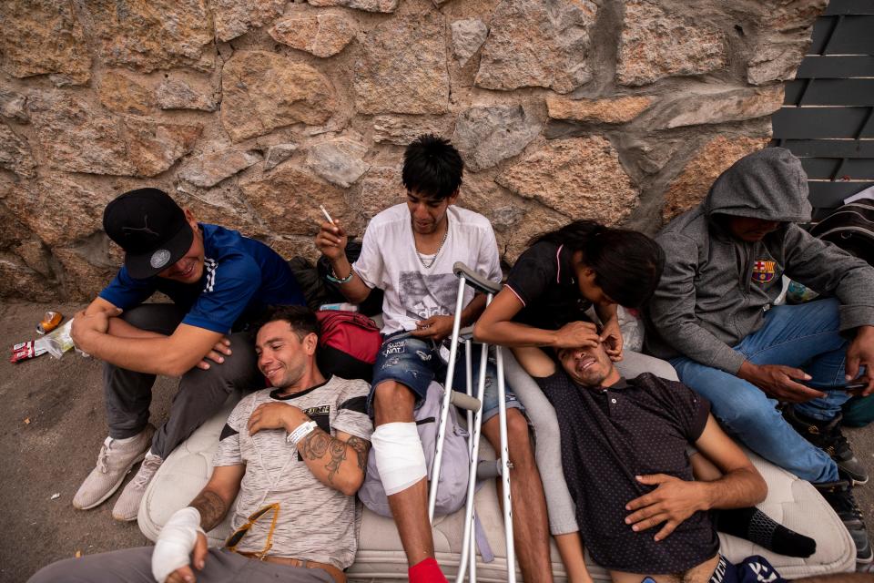 Migrants rest on a mattress they call home a camp in an alley behind the Opportunity Center for the Homeless in El Paso, Texas on May 3, 2023. Hundreds of migrants are seeking refuge at the homeless center. 