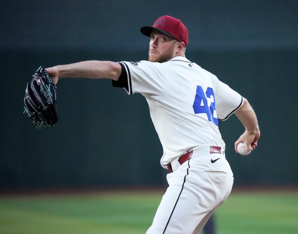 Arizona Diamondbacks starting pitcher Merrill Kelly throws against the Chicago Cubs during the first inning at Chase Field in Phoenix on April 15, 2024. All players are wearing number 42 in honor of Jackie Robinson Day.