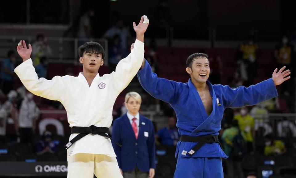 Japan’s Naohisa Takato, in blue, celebrates gold in the men’s under 60kg judo.