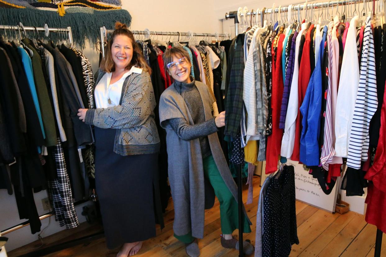 Casey Philbrick, left, and Stella McShera, co-founders of The Clothing Library, pose with some of the outfits that will be available for borrowing at the Dover Public Library. The clothes are either thrifted or donated, and the program aims to promote sustainable fashion.