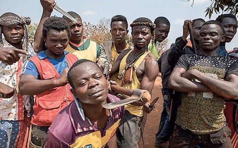 A group of Christian Anti-Balaka militants show off their weapons - Credit: Alberto Maretti / Redux / eyevine