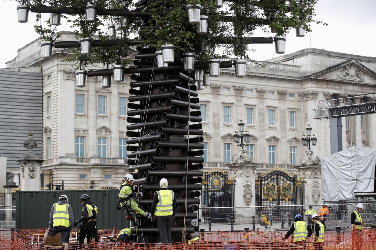 A team of workers adds the final parts to the Queen's Green Canopy ahead of the Platinum Jubilee in London, Tuesday, May 24, 2022.