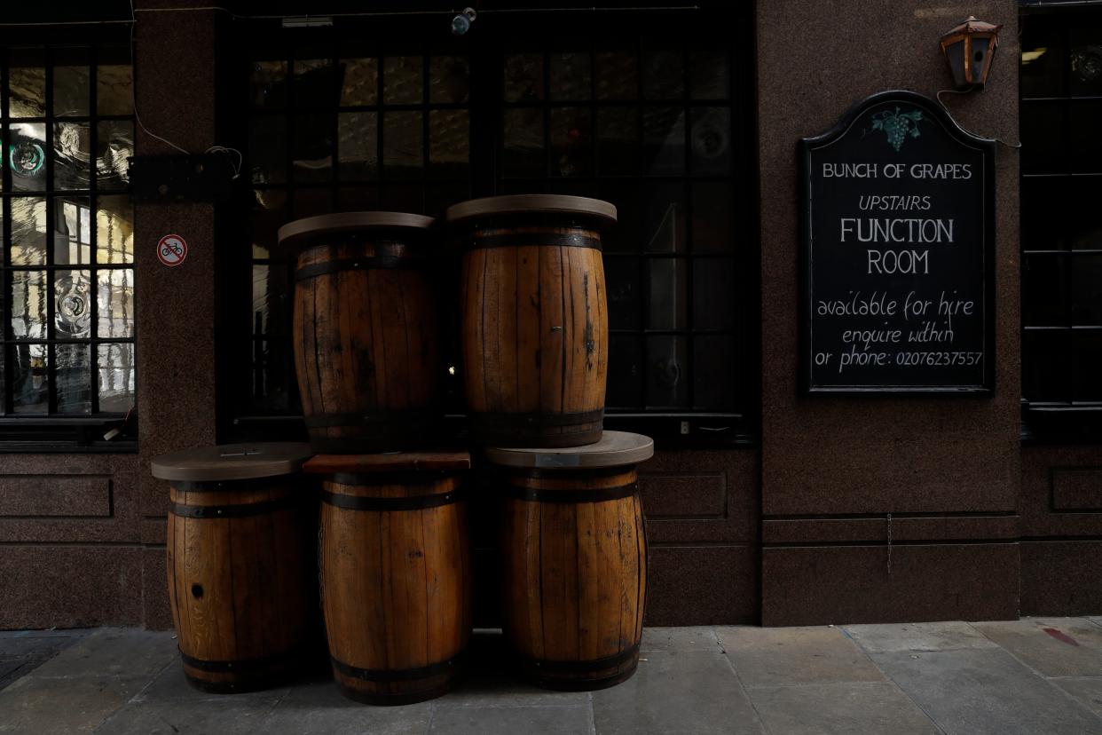 <p>File image: Barrel tables stand stacked up outside a temporarily closed pub in London</p> (AP)