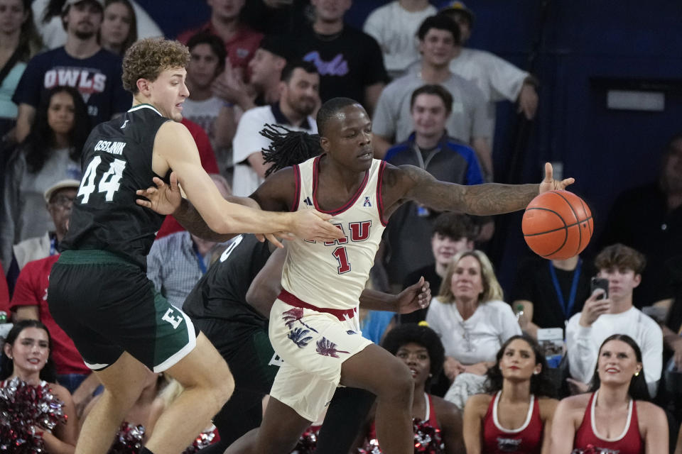 Florida Atlantic guard Johnell Davis (1) fends off Eastern Michigan guard Arne Osojnik (44) during the first half of an NCAA college basketball game Tuesday, Nov. 14, 2023, in Boca Raton, Fla. (AP Photo/Rebecca Blackwell)