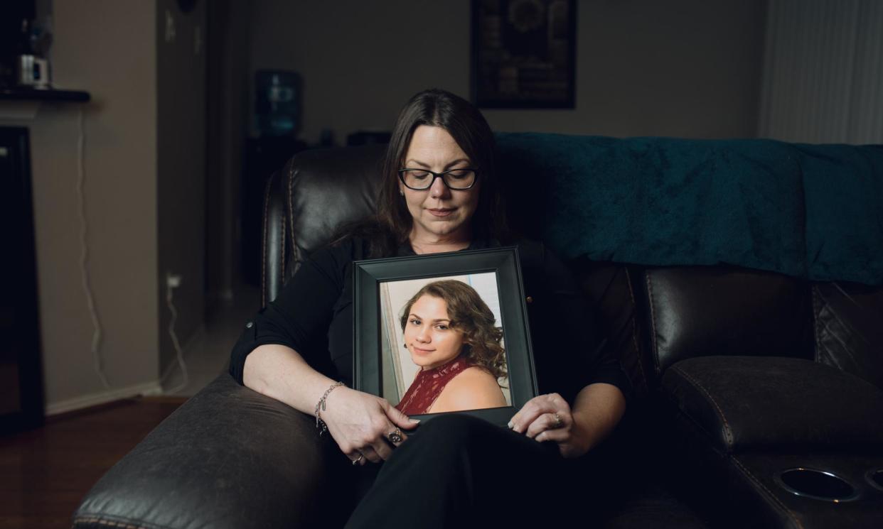 <span>Robyn Cory at home in Houston with a photo of her daughter Kristen. ‘My message for other parents is: don’t let your kids have social media,’ says Cory.</span><span>Photograph: Tola Olawale/The Guardian</span>