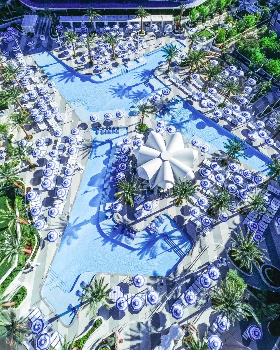 As the newest pool in town in 2024, the Oasis Pool deck at the <a href="https://www.cntraveler.com/hotels/las-vegas/fontainebleau-las-vegas?mbid=synd_yahoo_rss" rel="nofollow noopener" target="_blank" data-ylk="slk:Fontainebleau Las Vegas;elm:context_link;itc:0;sec:content-canvas" class="link ">Fontainebleau Las Vegas</a> has thought of everything a reveler with discerning tastes could want from a Vegas pool scene. There are seven pools, five bars, two restaurants, a gaming area, and to top it all off, LIV Beach, a day club spin-off of the Miami Beach hotspot, LIV. The pool deck, like the rest of the resort, does its best to conjure up Miami Beach of the 1950s and the French Riviera with cerulean blue and white furniture, copious palm trees, a stunning white Art Deco-styled pavilion bar and La Côte, a restaurant serving French-Mediterranean cuisine with an expansive rosé all day wine menu.