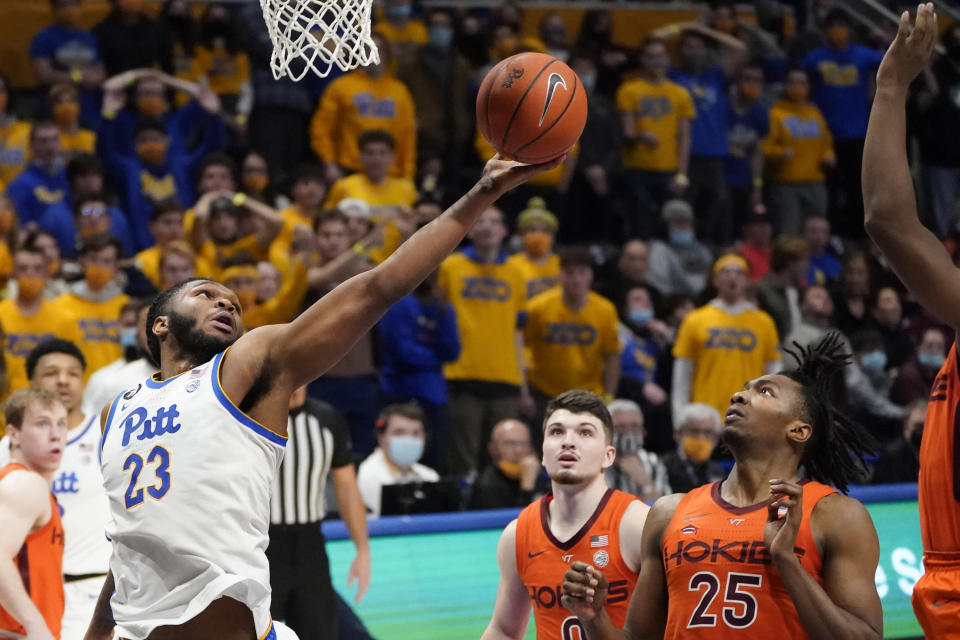 Pittsburgh's John Hugley (23) shoots after getting by Virginia Tech's Justyn Mutts (25) during the second half of an NCAA college basketball game, Saturday, Feb. 5, 2022, in Pittsburgh. (AP Photo/Keith Srakocic)