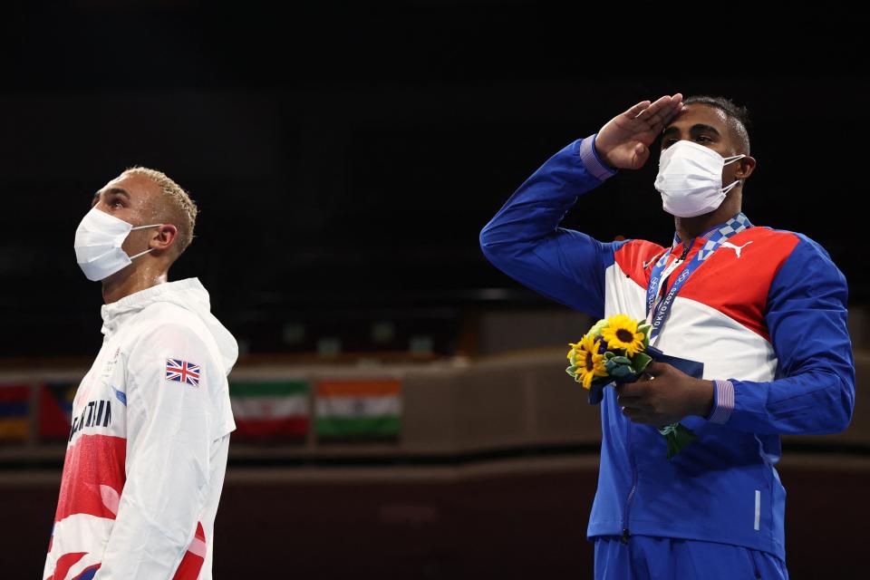 Gold medallist Cuba's Arlen Lopez (R) celebrates on the podium next to silver medallist Britain's Benjamin Whittaker after their men's light heavy (75-81kg) boxing final bout during the Tokyo 2020 Olympic Games at the Kokugikan Arena in Tokyo on August 4, 2021. (Photo by Buda Mendes / POOL / AFP) (Photo by BUDA MENDES/POOL/AFP via Getty Images)