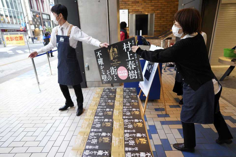 Shop clerks prepare to sell Japanese writer Haruki Murakami's new novel "The City and Its Uncertain Walls" on the first day for sale at Kinokuniya bookstore in Shinjuku district early Thursday, April 13, 2023, in Tokyo. (AP Photo/Eugene Hoshiko)