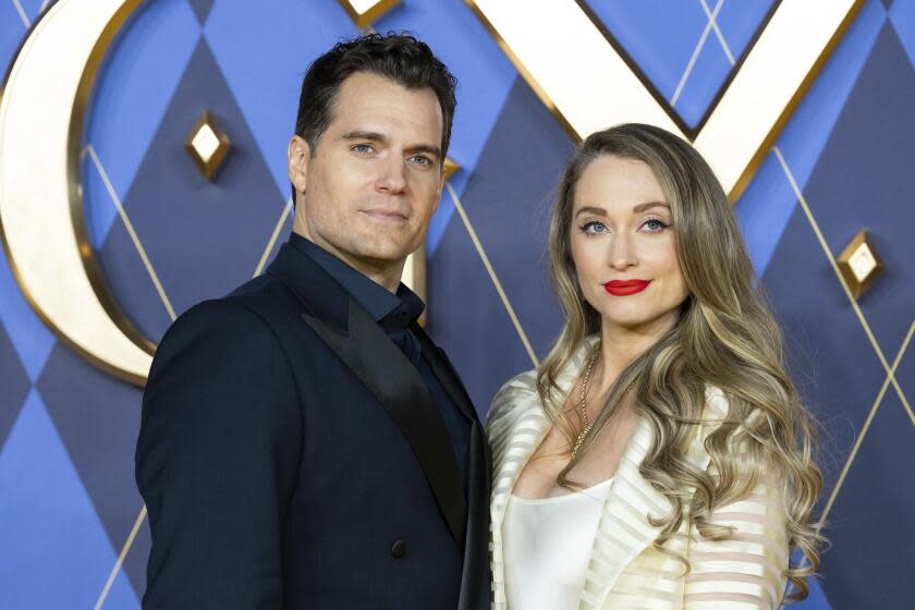 Henry Cavill, left, and Natalie Viscuso pose for photographers at a movie premiere