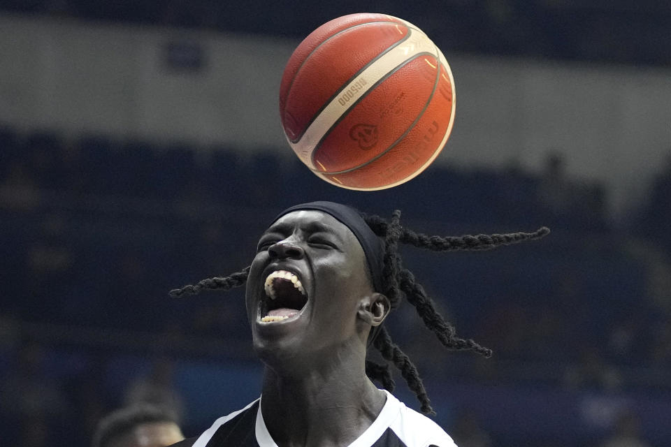 South Sudan center Deng Acuoth (12) react after scoring against Angola during their Basketball World Cup classification match at the Araneta Coliseum in Manila, Philippines on Saturday Sept. 2, 2023. (AP Photo/Aaron Favila)