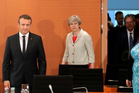 France's President Emmanuel Macron, British Prime Minister Theresa May and Italian Prime Minister Paolo Gentiloni prior to a gathering of European leaders on the upcoming G-20 summit in the chancellery in Berlin, Germany, June 29, 2017. REUTERS/Markus Schreiber/POOL