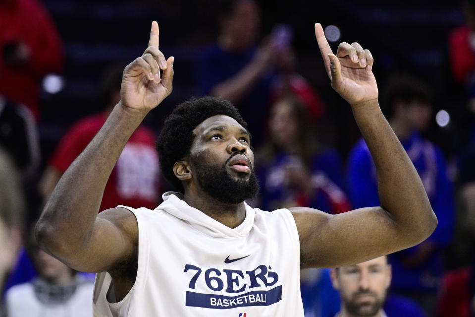 Philadelphia 76ers' Joel Embiid walks onto the court for warm-ups before Game 1 of an NBA basketball first-round playoff series against the Brooklyn Nets, Saturday, April 15, 2023, in Philadelphia. (AP Photo/Derik Hamilton)