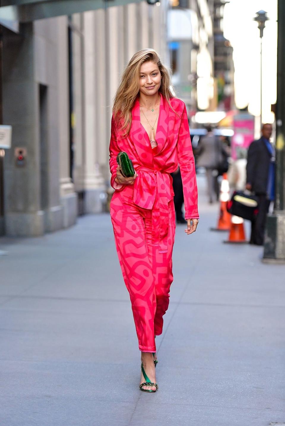 <p>Well, the just-rolled-out-of-bed look will never be the same again. Gigi dominated in a silky pajama-inspired jumpsuit and green accessories with zero makeup. </p>