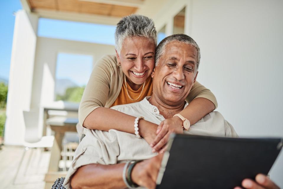 Two people looking at laptop.