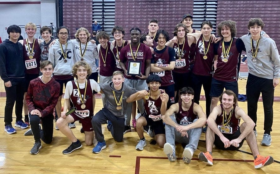 Athletes from the Ayer-Shirley boys' indoor track team celebrate winning the Mid-Wach D Championship on Friday at Fitchburg High.